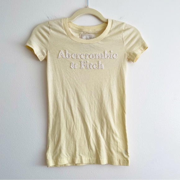 Abercrombie & Fitch Tops - Abercrombie and fitch butter yellow spell out tee shirt 3d logo baby tee y2k XS